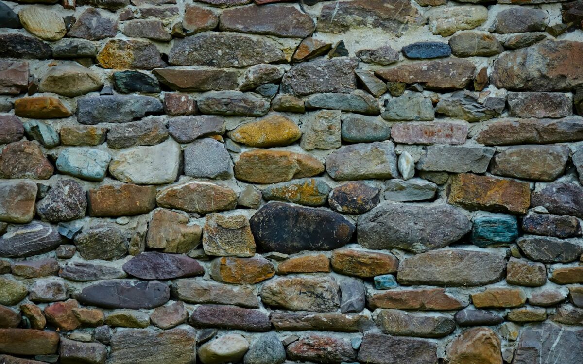 a stone wall made of various colored rocks