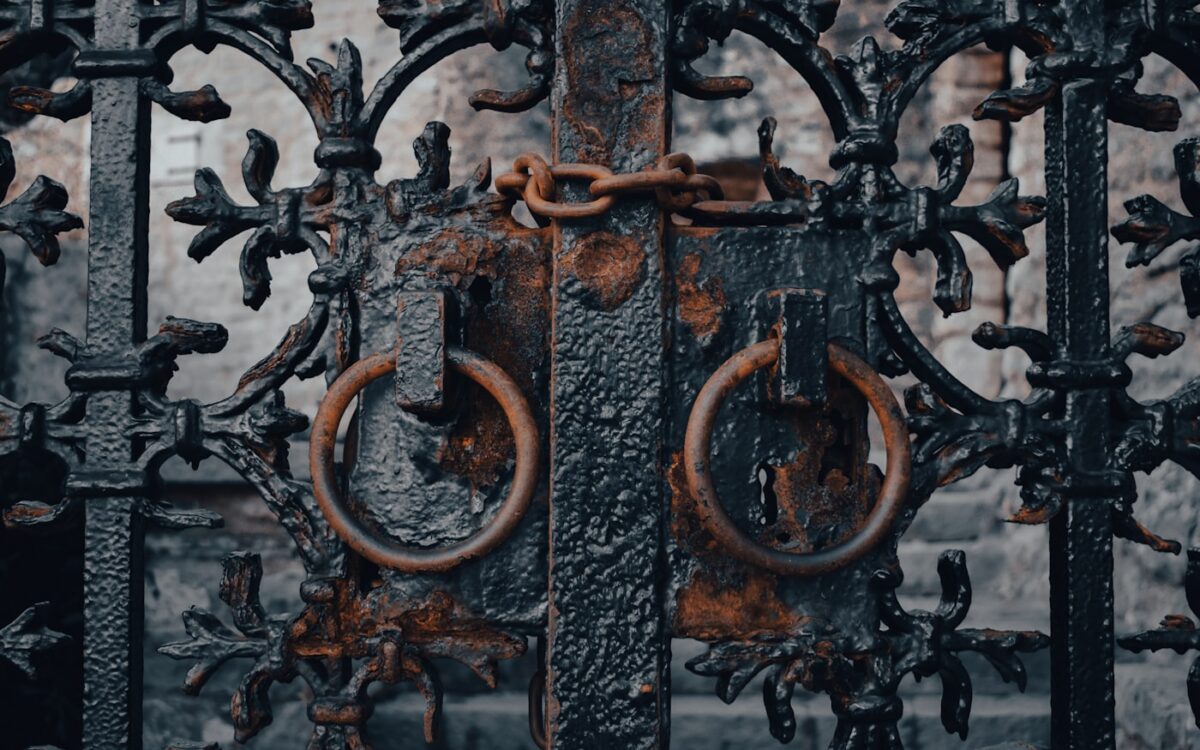 a close up of a metal gate with rust