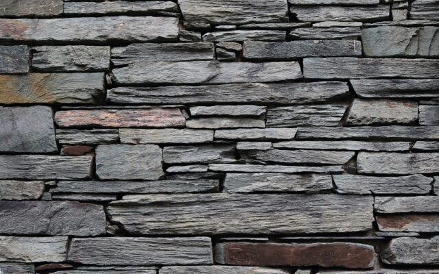 minimalist photography of gray rock wall