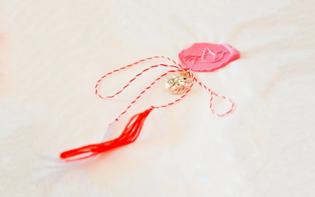 a pair of scissors and a string with a heart on it