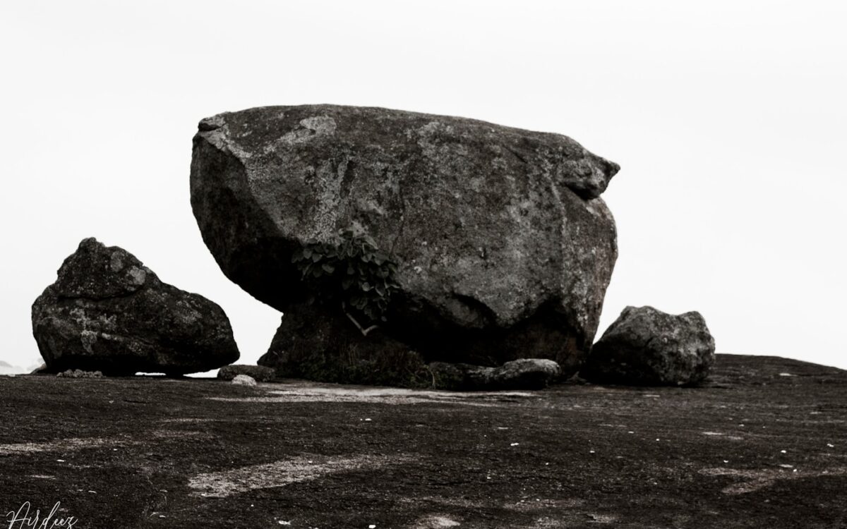 gray rock formation on brown sand during daytime