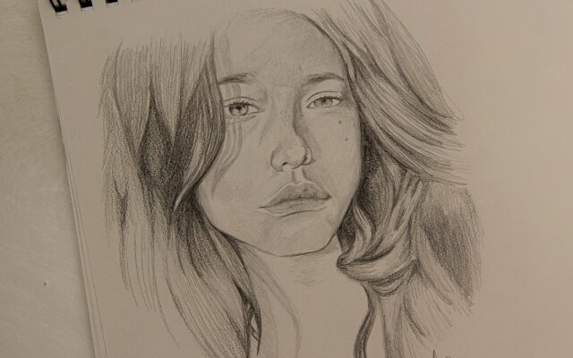 womans face sketch on white paper
