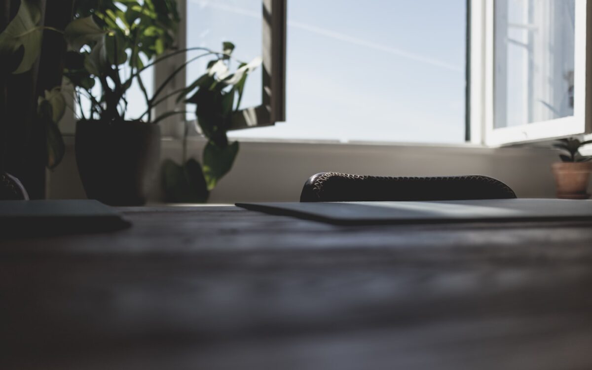 a laptop computer sitting on top of a wooden desk