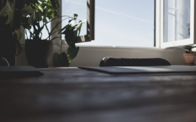 a laptop computer sitting on top of a wooden desk