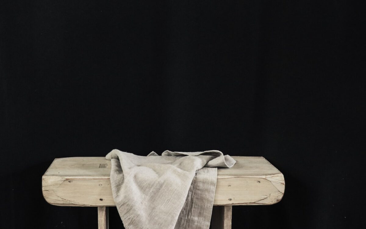 white textile on brown wooden table