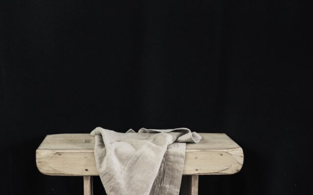 white textile on brown wooden table