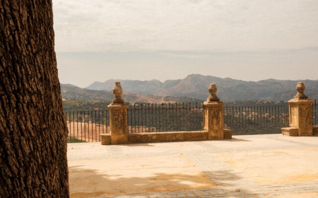 Stone balcony overlooking rolling hills and mountains