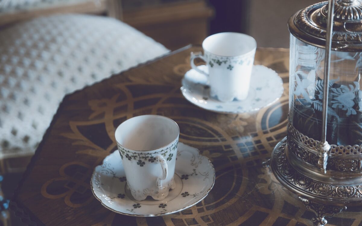 two cups and saucers sitting on a table