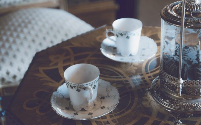 two cups and saucers sitting on a table