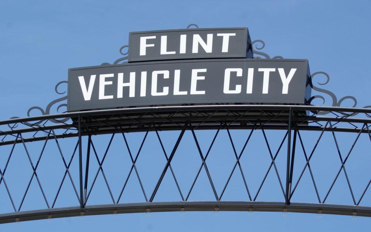 a black and white sign that reads flint vehicle city