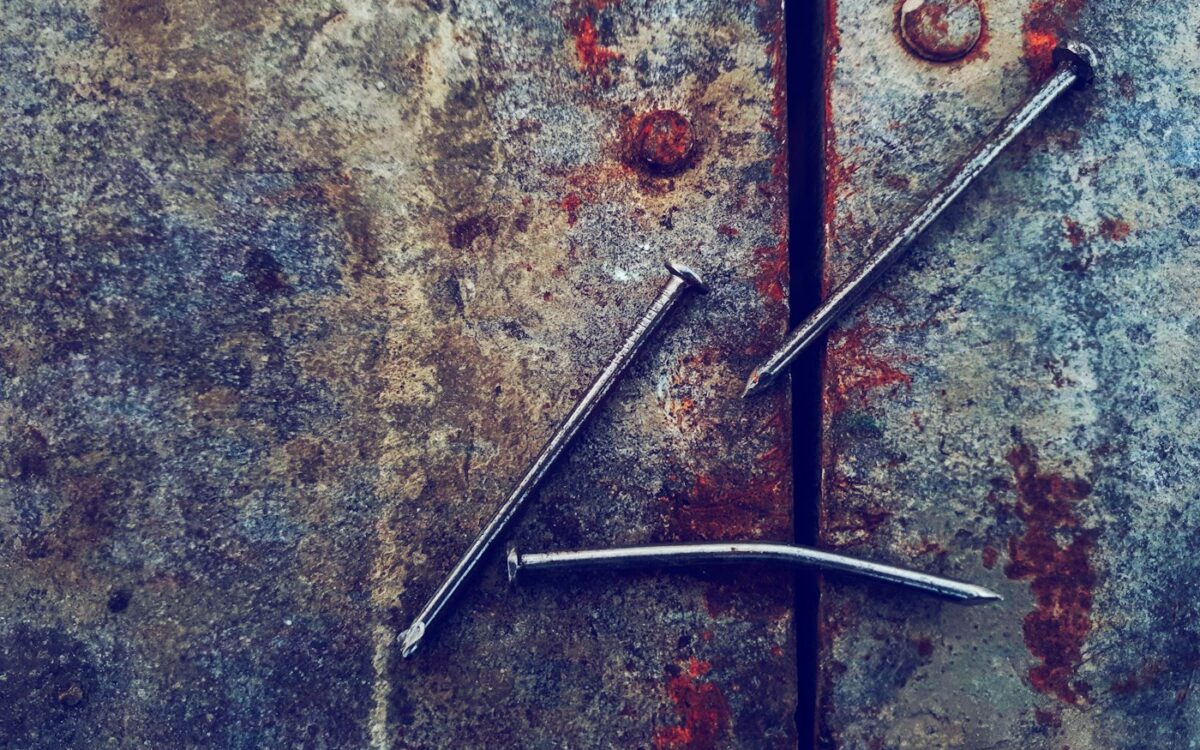 three grey metal nails