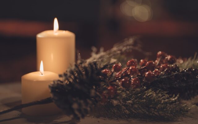 white pillar candle on brown wooden table