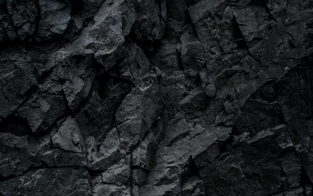 a close up of a black rock wall