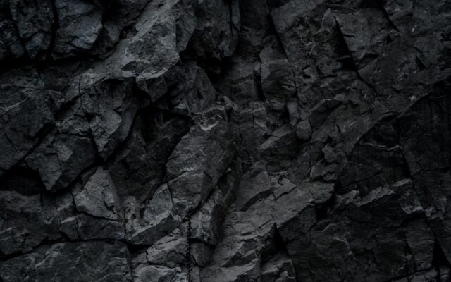 a close up of a black rock wall