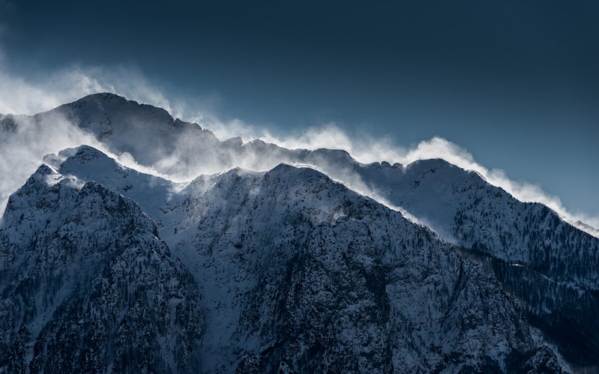 snow-covered mountains under clear sky during daytime