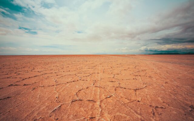empty desert under white cloudy sky at daytime