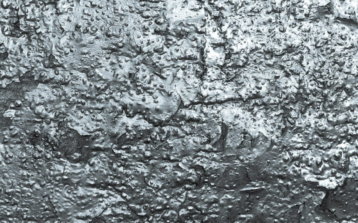 a black and white photo of the surface of a wall