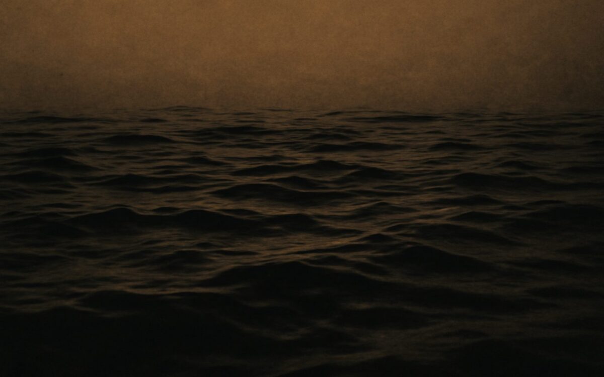 Deep dark water surface, evoking the 2032 Water Rat year in the Chinese zodiac