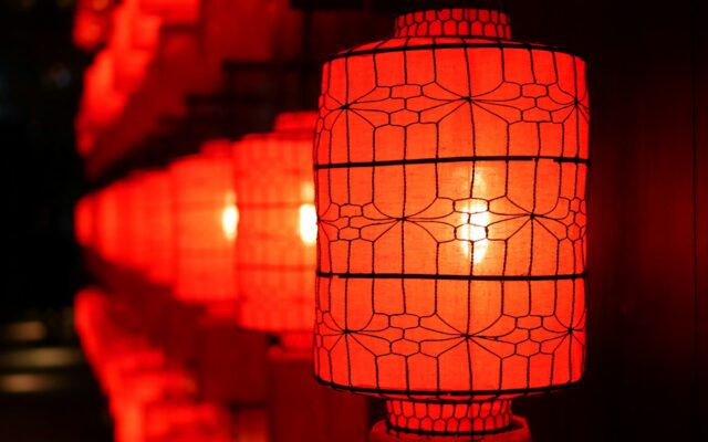 Glowing red paper lanterns in a row, celebrating Chinese New Year 2027 and the Fire Goat (Ding Wei) year