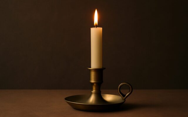 Candle with brass detail, reflecting the Fire Rooster (Ding You) year in Chinese astrology