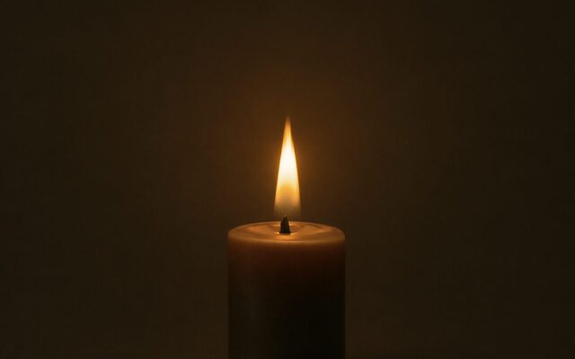 Candle flame glowing in the dark, evoking Ding Fire for the hour stem table of Ding days