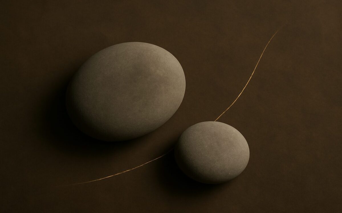 Two smooth river stones side by side, evoking Snake and Dog compatibility